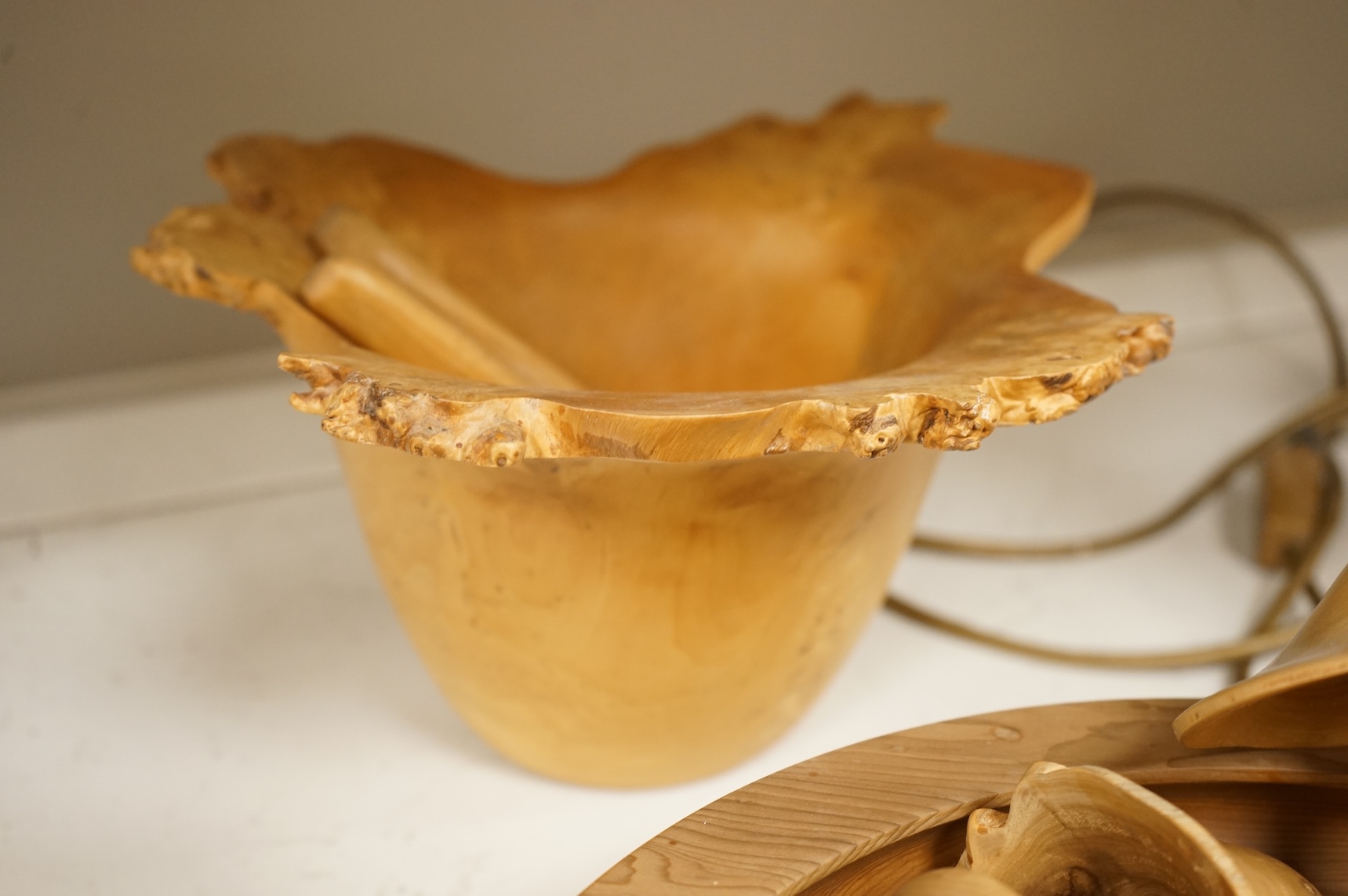 A modern treen yew bowl, a burr wood bowl and various fruit